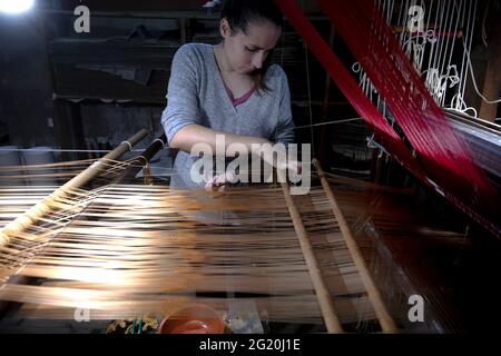 Traditional Bevilacqua weavers workshop, handycraft women work on more than 200 years old wooden loom weavings, in Venice since 1875 . Stock Photo