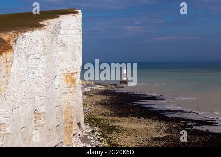 The lighthouse at Beachy Head sits alongside the white cliffs of the South Downs in East Sussex. Stock Photo