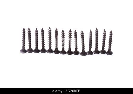 Self-tapping screws lined up on hats isolated on white background Stock Photo
