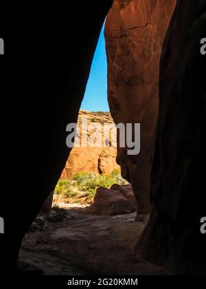 Looking out through the entrance of Dry gulch, a slot canyon in the in the Grand Staircase-Escalante National Monument, Utah, USA Stock Photo