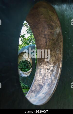 Two Forms (Divided Circle) (1969), glimpsed through Four-Square (Walk Through) (1966), Barbara Hepworth Sculpture Garden, St. Ives, Cornwall, UK Stock Photo