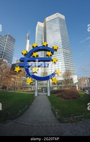 Euro Sculpture (Euro-Skulptur) at Willy-Brandt-Platz with Eurotower on background - Frankfurt, Germany Stock Photo