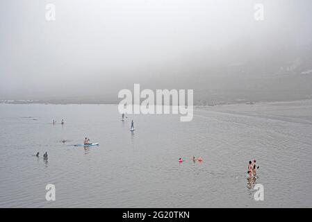 Wild swimming in the haar or sea fog at Wardie Bay on the Firth of Forth, Edinburgh, Scotland, UK. Stock Photo