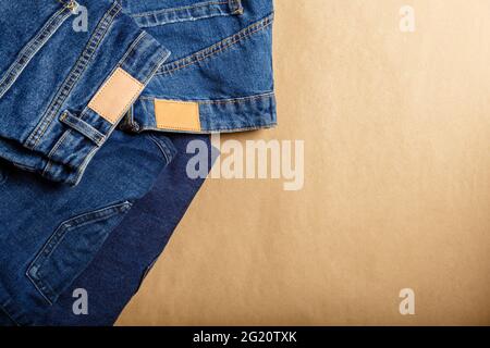 Denim clothes. Many different assortment of denim pants models. Classic blue jeans. Casual pants clothing blue jeans with brown blank leather labels Stock Photo