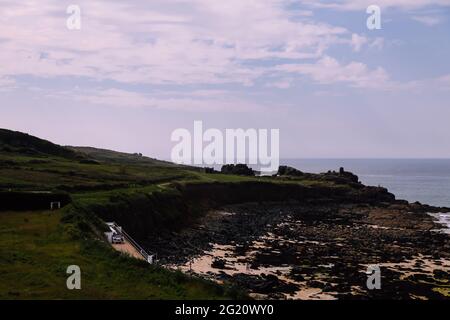 View of Mans Head peninsula from Porthmeor beach, St. Ives, Cornwall, UK, May 2021 Stock Photo