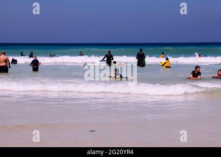 Surfers surfing on bank holiday half term, Porthmeor beach, St. Ives, Cornwall, UK, May 2021 Stock Photo