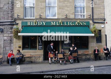 Male members of the Scottish family take a break in the pub before the wedding ceremony they will attend, dressed in their traditional clothes. Stock Photo