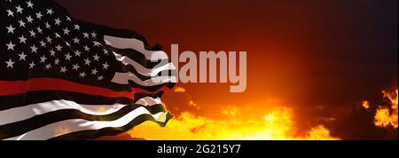 Thin Red Line. Black Flag of USA with Firefighter red Line waving in the wind on flagpole against the sky with clouds on sunny day. 3d illustraion. Stock Photo