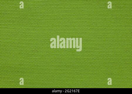 Background image - textured natural coarse green fabric. Stock Photo