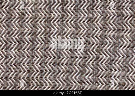 Background image - textured natural rough fabric of gray tones with a herringbone pattern. Stock Photo