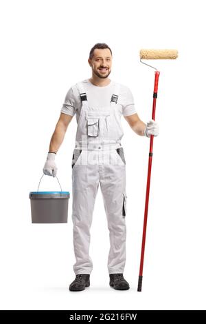 Full length portrait of a painter in a white uniform with a bucket and a paint roller isolated on white background Stock Photo