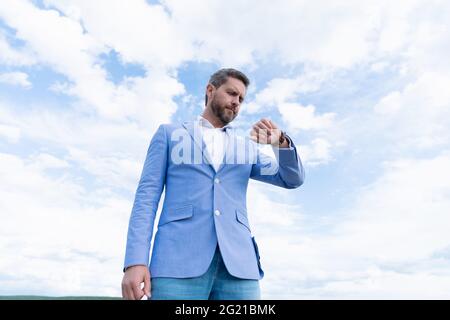 Man in elegant formal wear and with bag is outside against modern building  Stock Photo - Alamy
