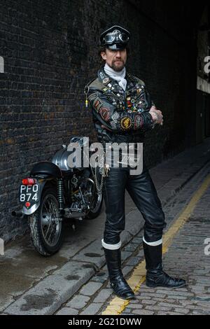 Rocker in cafe racer gear wearing black leather jacket covered in studs ...