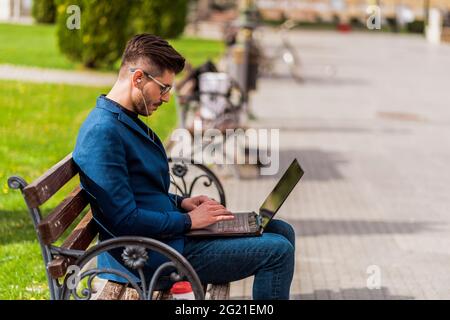 Experienced male freelancer connecting to wireless via net-book during lunch break Stock Photo