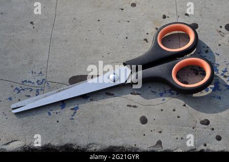 Used modern scissors are placed outdoors Stock Photo