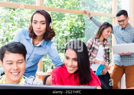 Creative dedicated young employees using modern technology while working on various projects in the office Stock Photo