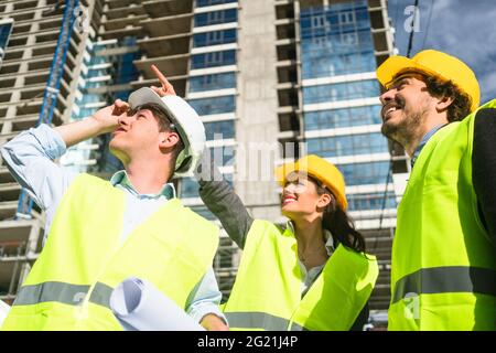 Team of architects and civil engineers inspecting construction site Stock Photo