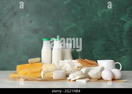 Different dairy products and chicken eggs on color background Stock Photo