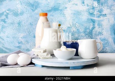 Different dairy products and chicken eggs on color background Stock Photo