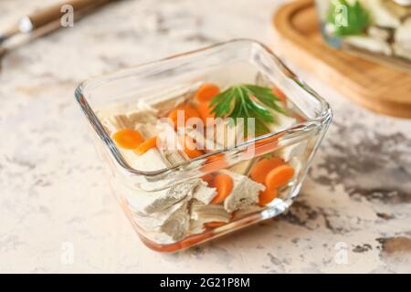 Bowl of tasty aspic on grunge background Stock Photo