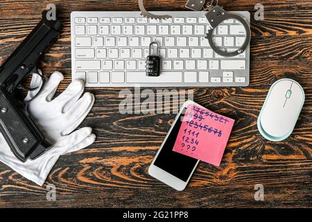 Composition with mobile phone and computer keyboard on wooden background. Hacking concept Stock Photo