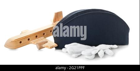 Stewardess hat with figure of plane and gloves on white background Stock Photo