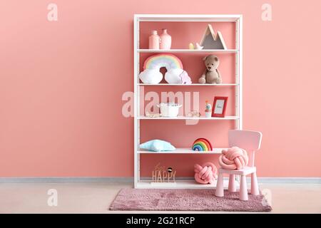 Shelf with toys and decor in children's room Stock Photo