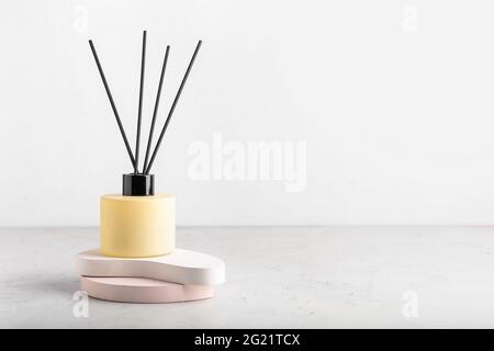 Reed diffuser on table against white background Stock Photo