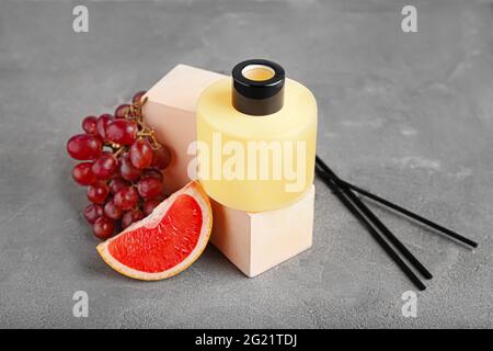 Reed diffuser with fruits on grunge background Stock Photo