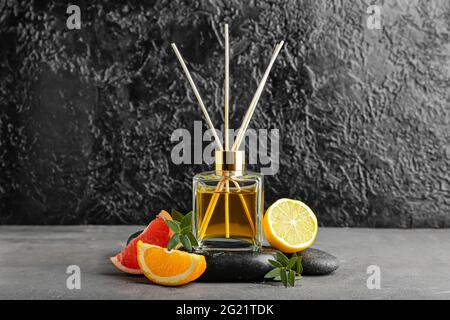 Citrus reed diffuser on dark background Stock Photo