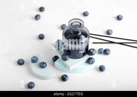 Reed diffuser with blueberries on white background Stock Photo