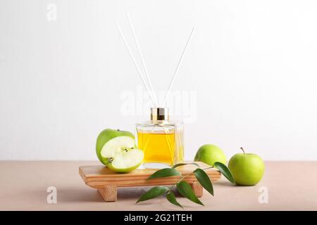 Reed diffuser with apples on table Stock Photo