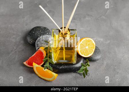 Citrus reed diffuser on grunge background Stock Photo