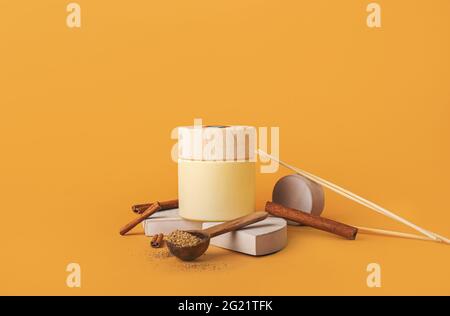 Reed diffuser with cinnamon on color background Stock Photo