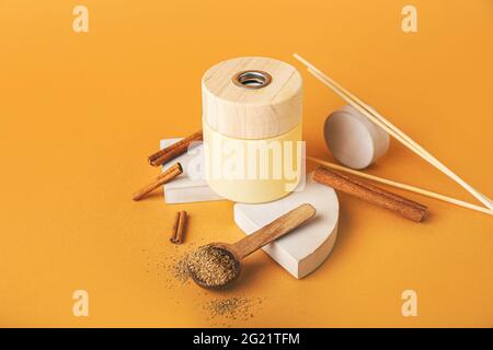 Reed diffuser with cinnamon on color background Stock Photo