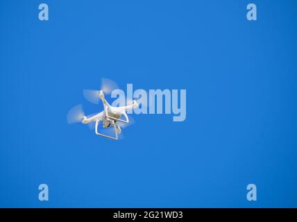 Drone flying in the clear blue sky Stock Photo
