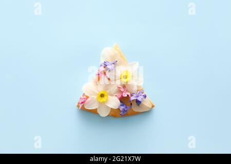 Creative composition with tasty pizza and flowers on color background Stock Photo