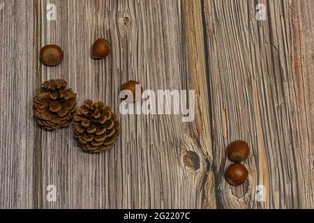 pine cones scattered on wooden background Stock Photo