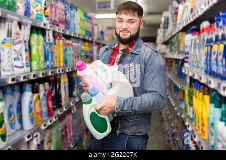 man standing with household chemicals Stock Photo