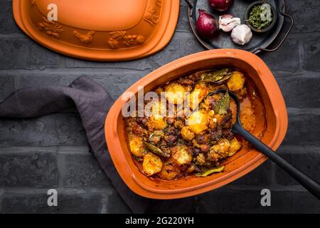 Homemade goulash with potatoes and sauerkraut. Beef and vegetable stew cooked in clay pot Stock Photo