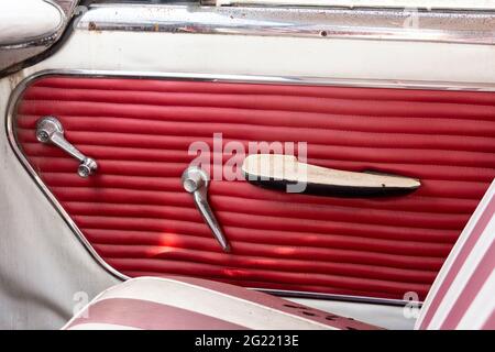 Bright pink interior door of a vintage car waiting to be restored. Stock Photo