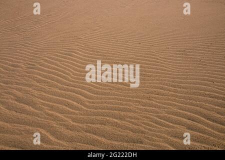 Close up of track marks of water left of beach sand Stock Photo