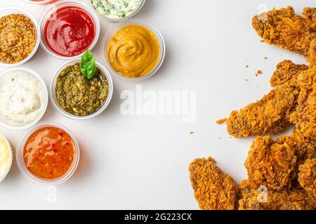 Chicken wings and assorted sauces on white background Stock Photo