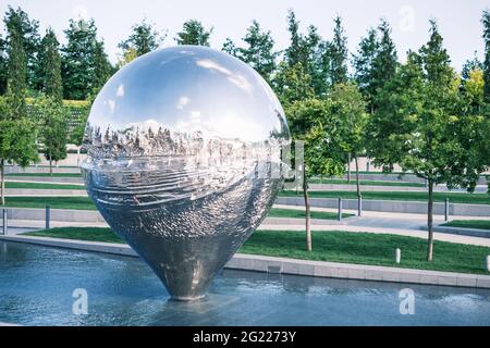 Art object sculpture Geolocation in the form of an inverted drop of metal. Stock Photo