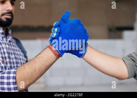 Constructional agreement. Handshake over autoclaved blocks Stock Photo
