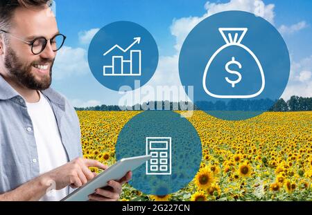 Happy agribusinessman using digital tablet for agriculture processes automatization Stock Photo