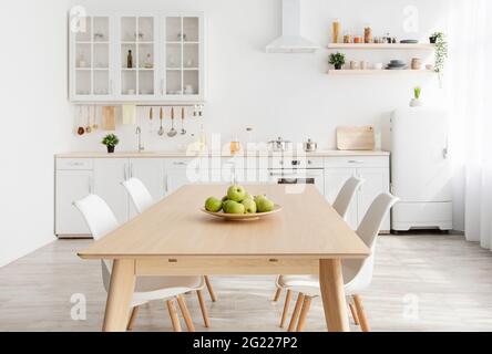 https://l450v.alamy.com/450v/2g227p2/scandinavian-contemporary-style-kitchen-with-eating-area-and-simplistic-accents-wooden-table-and-white-furniture-2g227p2.jpg