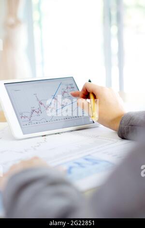 Close-up Of Businesswoman Analyzing Graph On Digital Tablet Stock Photo