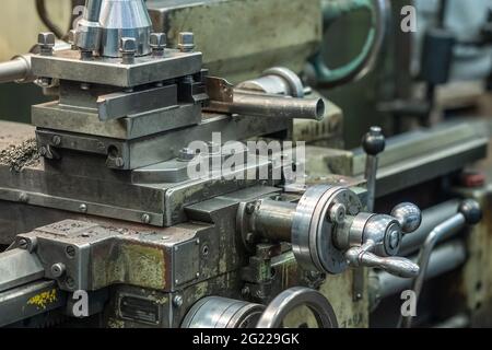 Machine tool for cutting and grinding metal products, metalwork equipment in factory. Stock Photo