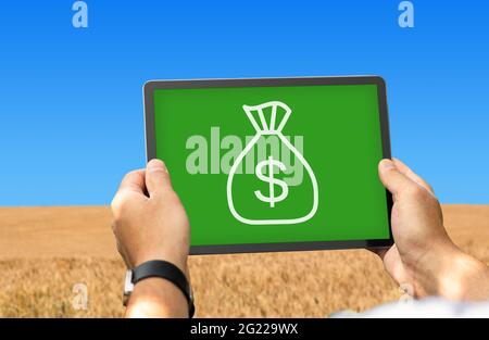 Agribusinessman using digital tablet for agriculture processes automatization Stock Photo